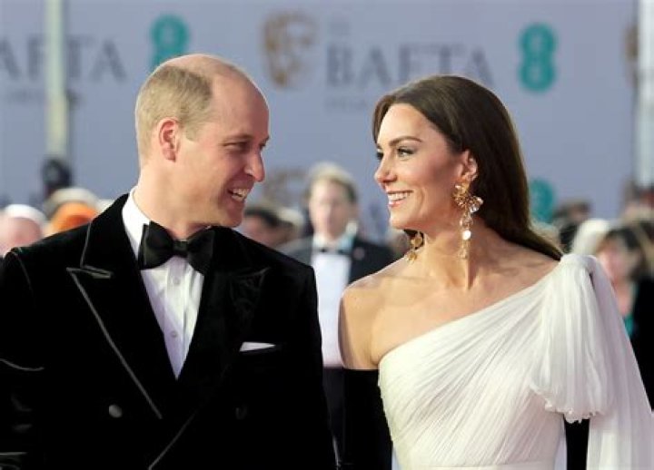 Kate Middleton and Prince William pose with their son