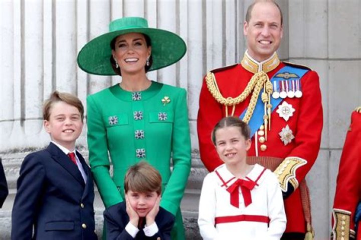 Prince George sits on the grass
