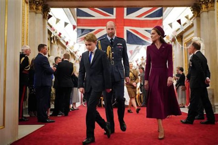 Prince George walking in front of Princess Charlotte